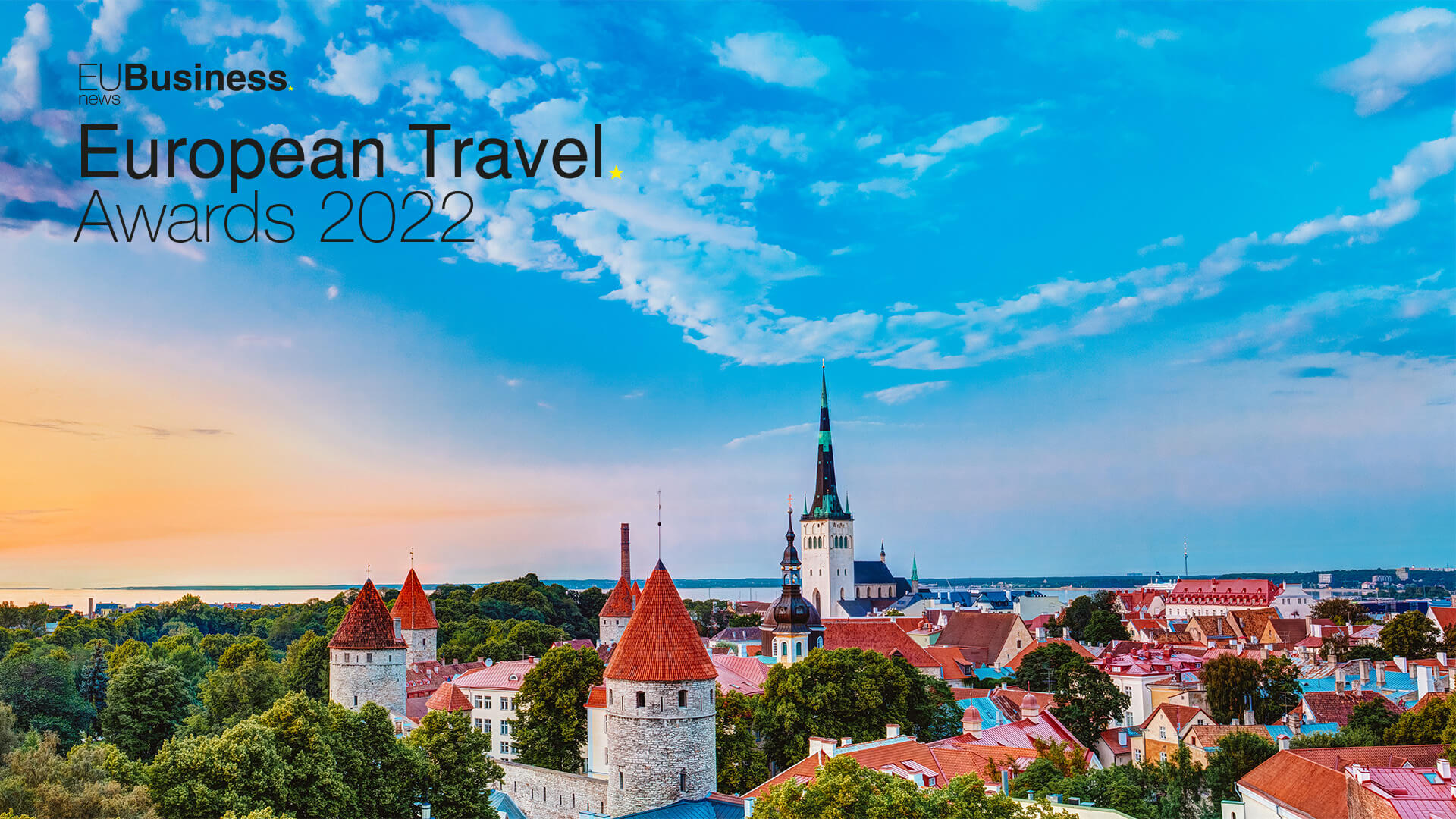 Tallinn, Estonia skyline at sunset. The EU Business News European Travel Awards logo is in the top left corner