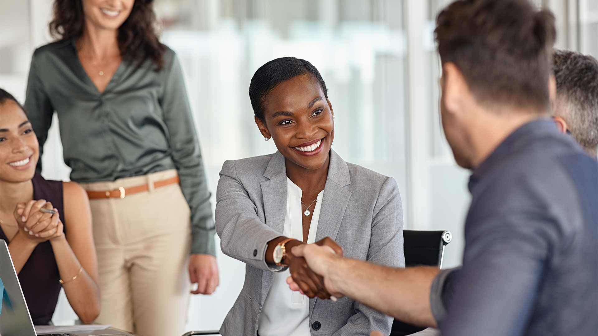 businesswoman shaking hands with new business partner