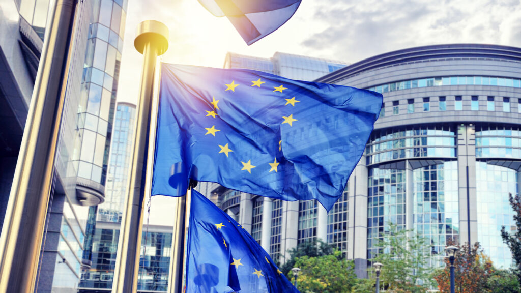 EU flags waving in front of European Parliament building in Brus