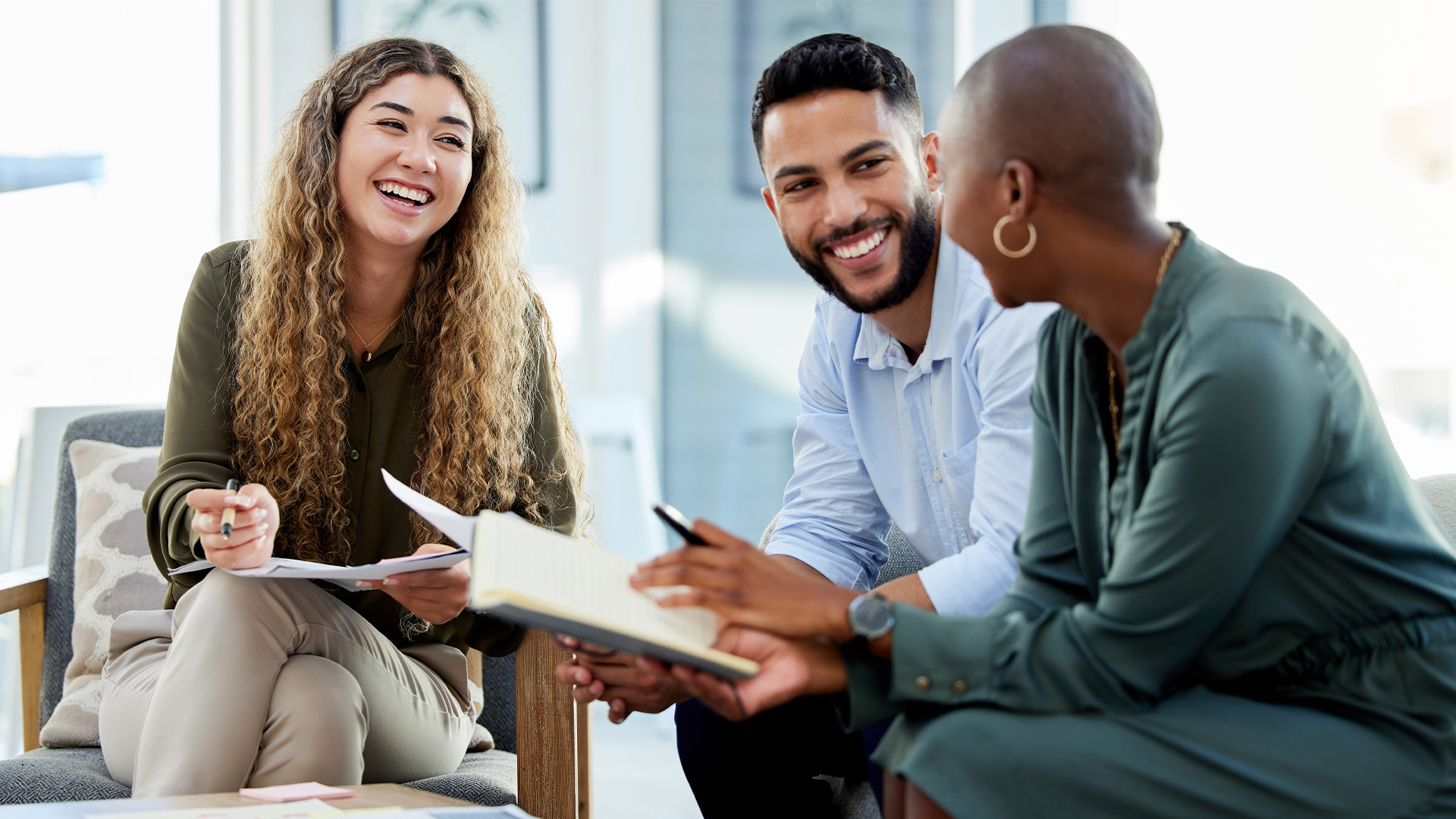 Happy business people smile during a planning meeting in a startup marketing agency office.